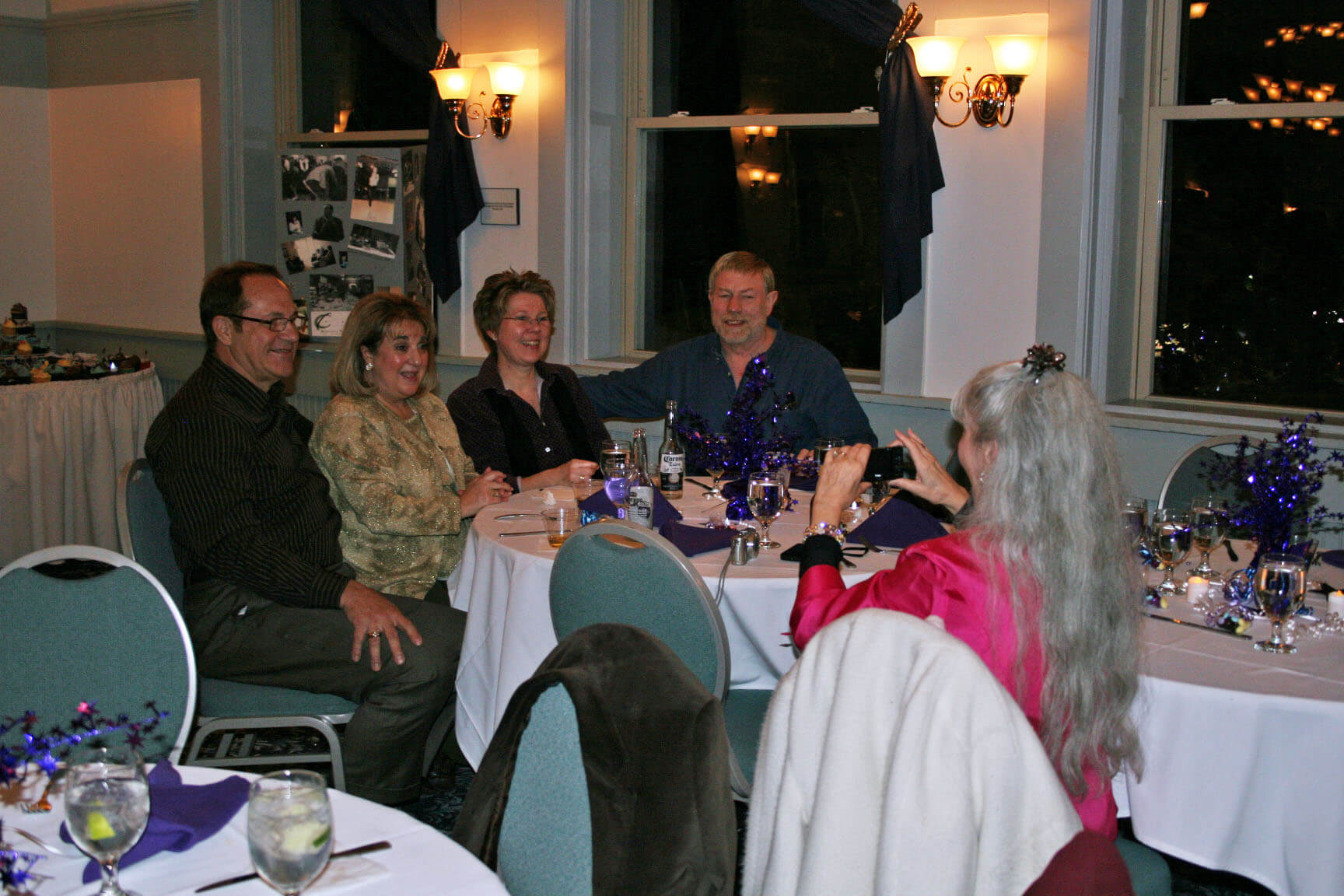 Carol Lavoie takes a photo of friends at her table. Dan Breidenbach is at the right of the group.